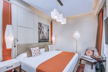 a bedroom with a bed and a chair