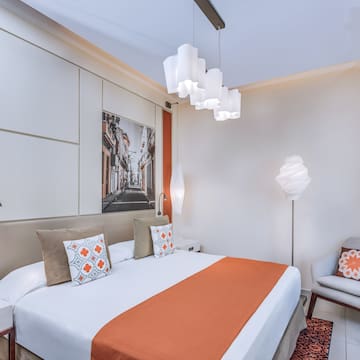 a bedroom with a bed and a chair