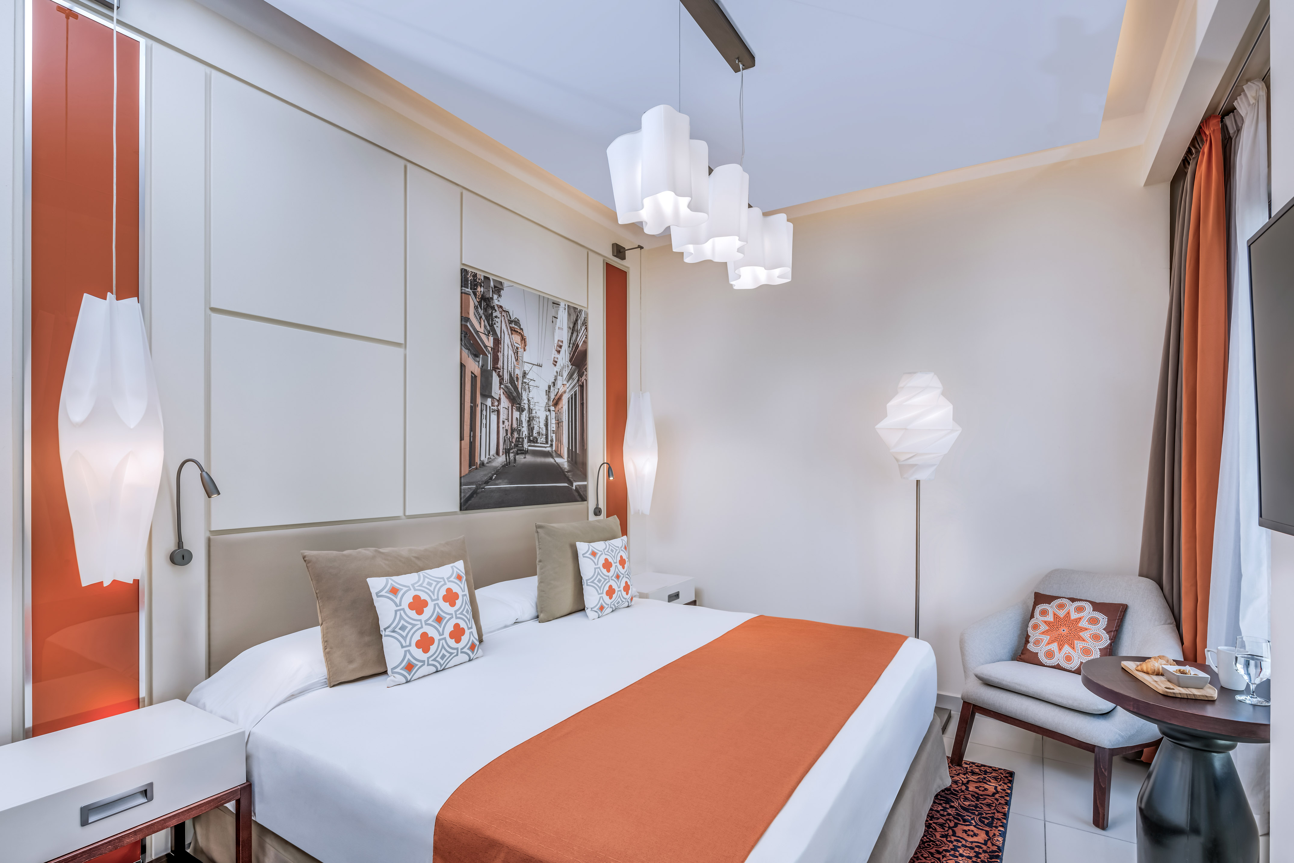 a bedroom with a bed and a chair