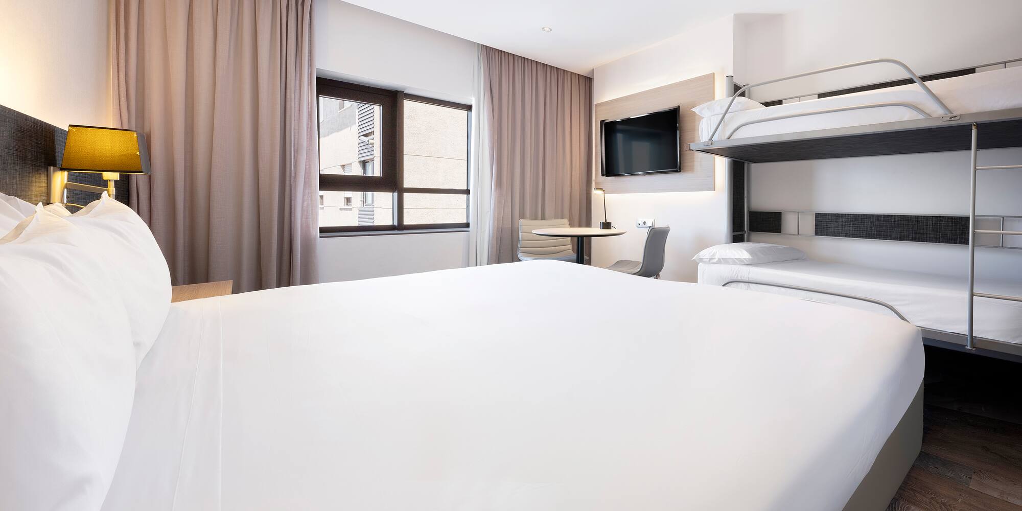 a room with a bunk bed and a tv