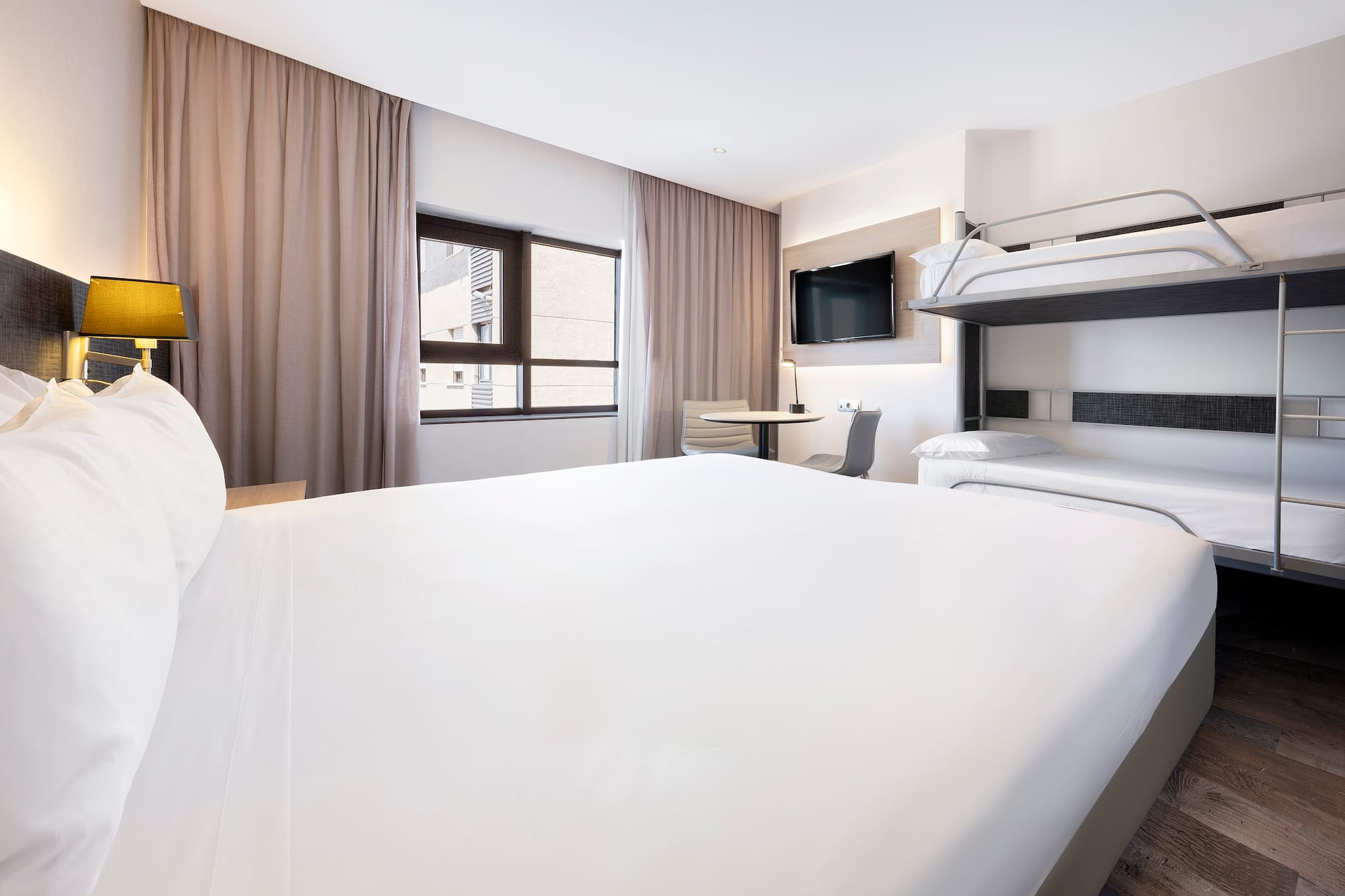 a room with a bunk bed and a tv