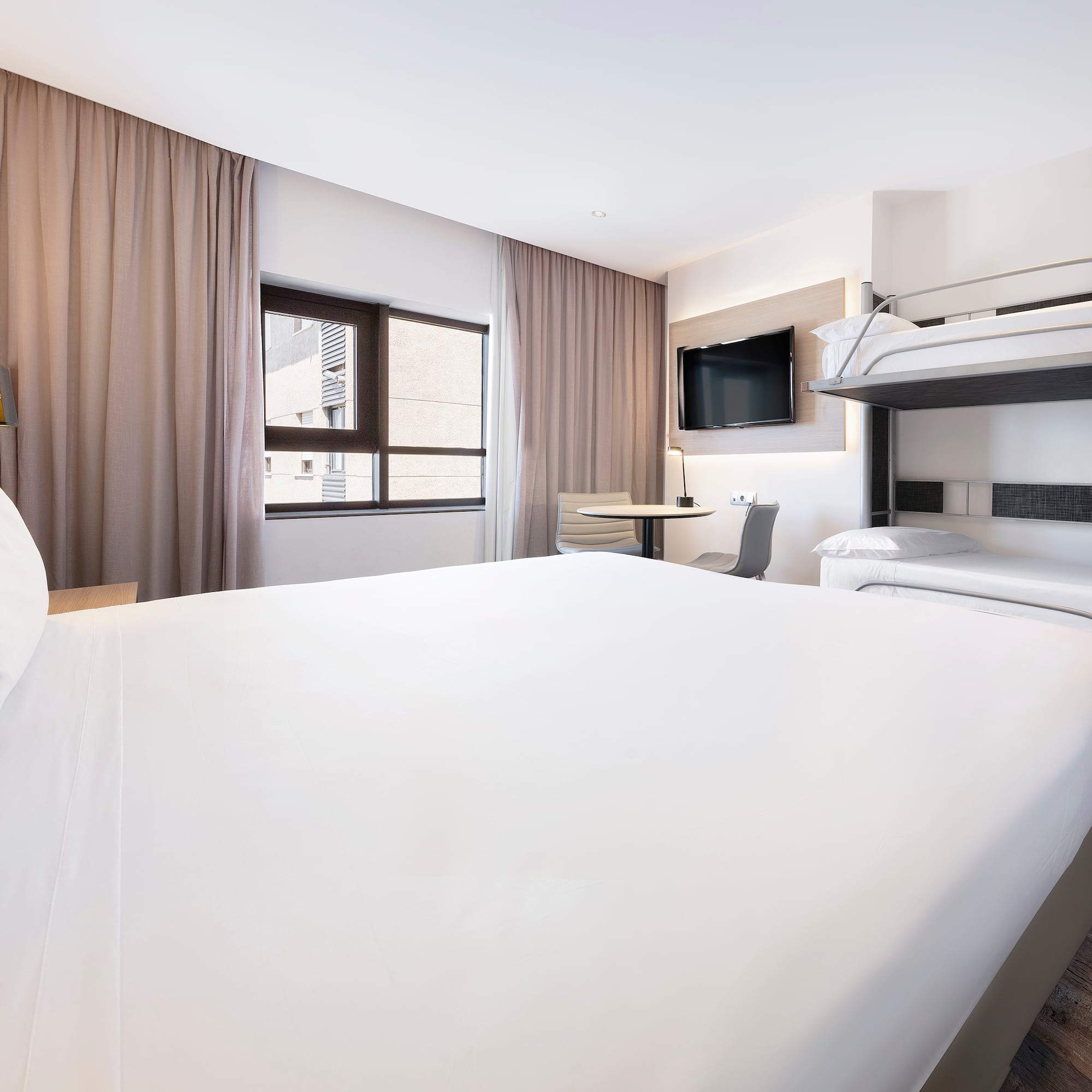 a room with a bunk bed and a tv