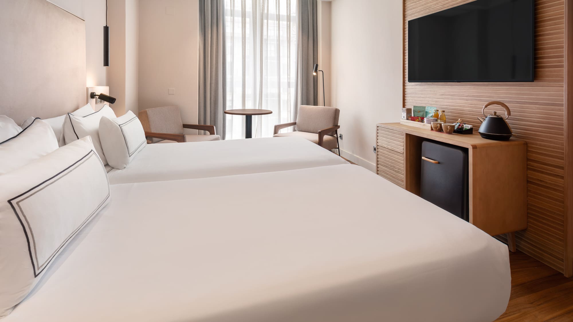 a room with two beds and a television