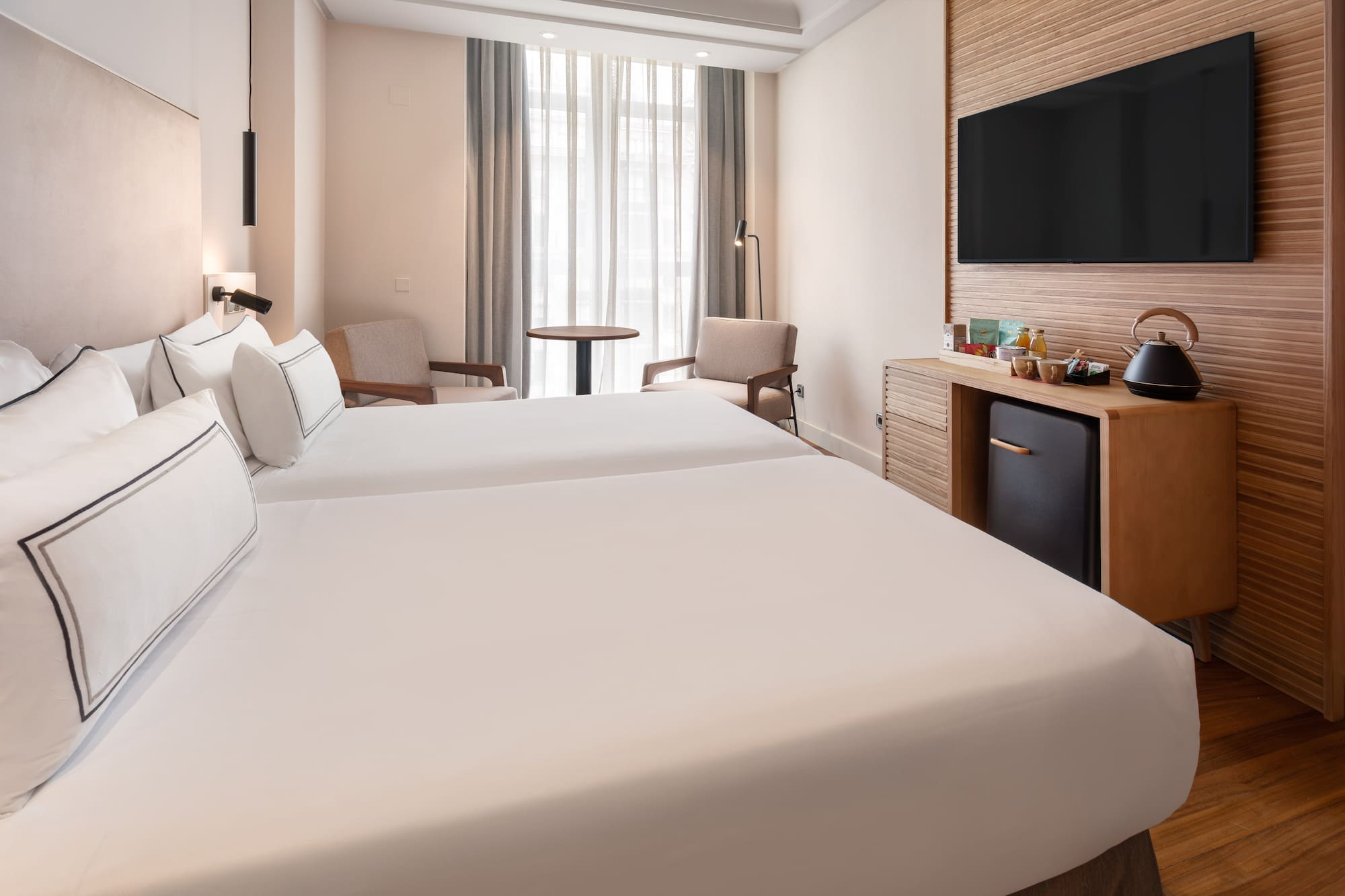 a room with two beds and a television