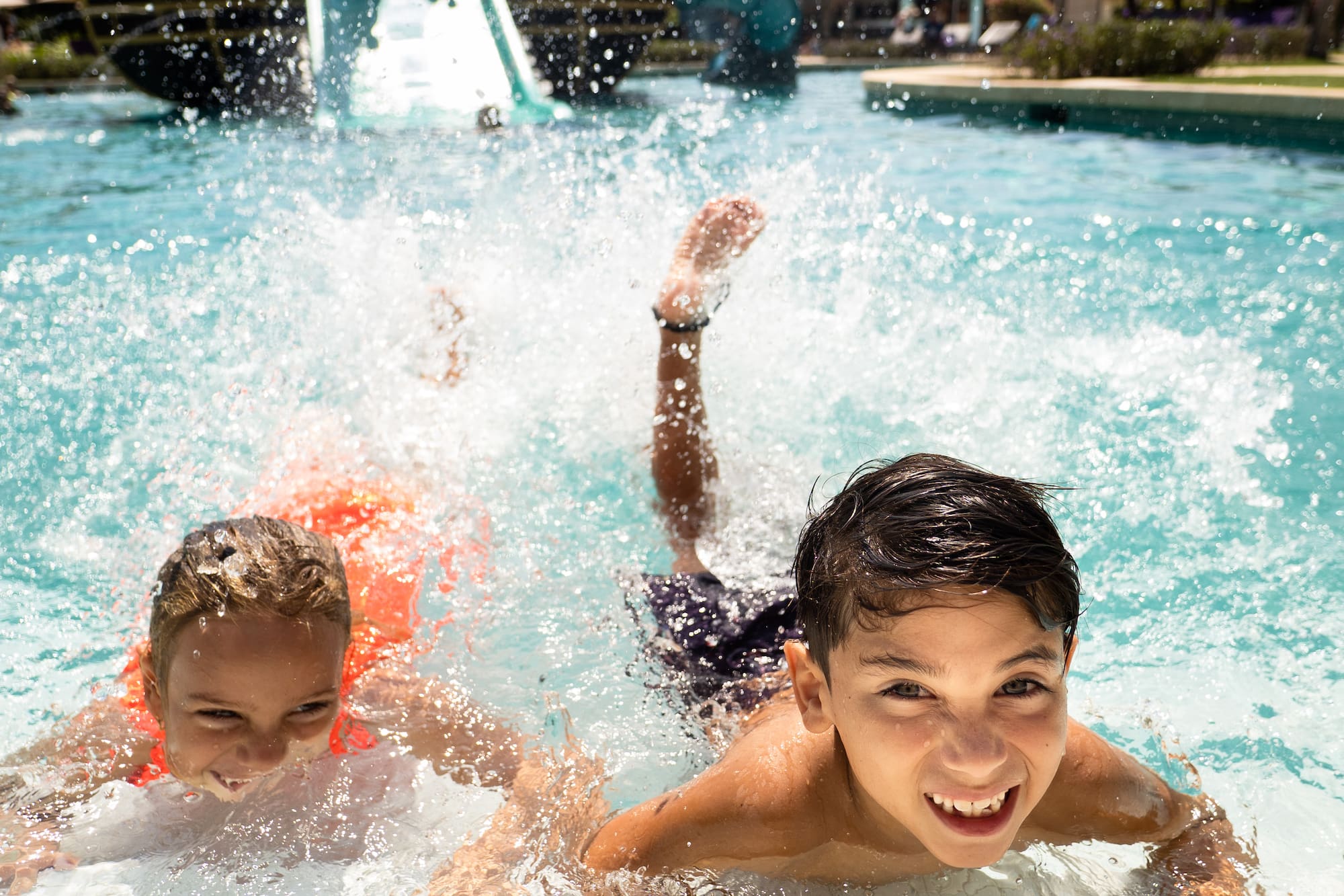 a group of kids swimming in a pool