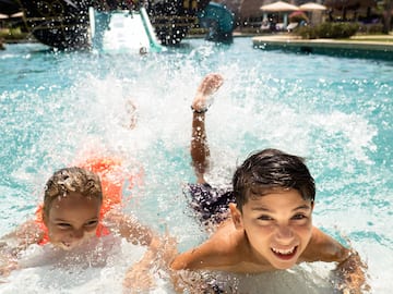 a group of kids swimming in a pool