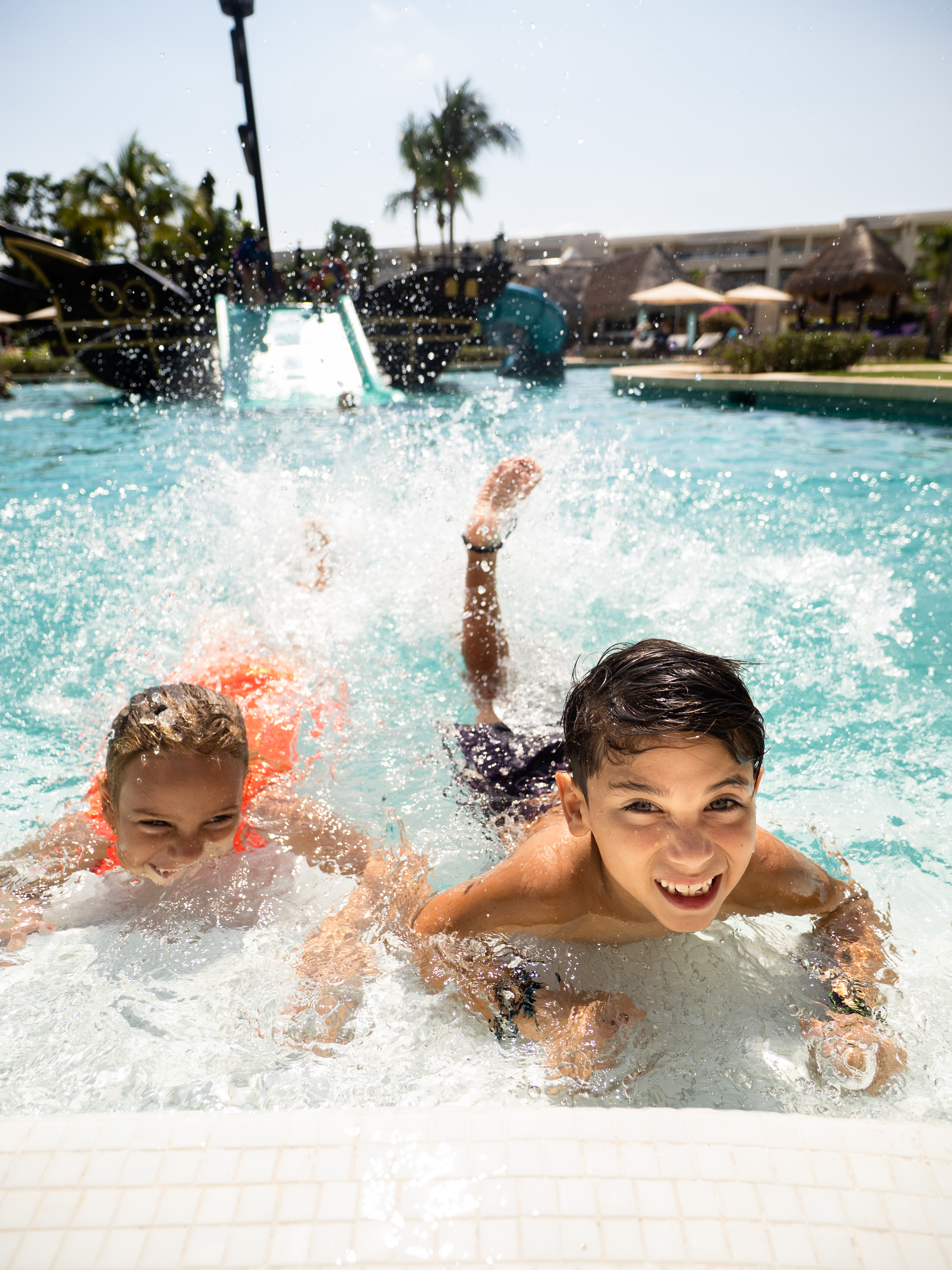 a group of kids swimming in a pool
