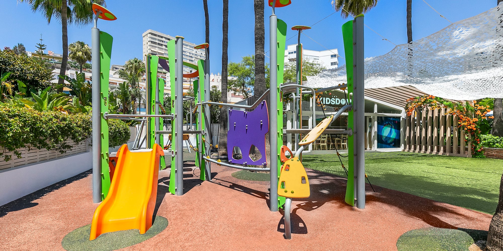 a playground with colorful slides and trees