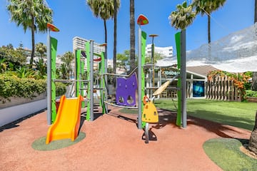 a playground with colorful slides and trees
