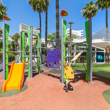 a playground with colorful slides and trees