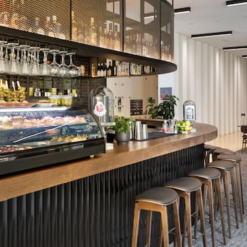 a bar with a counter and wine glasses