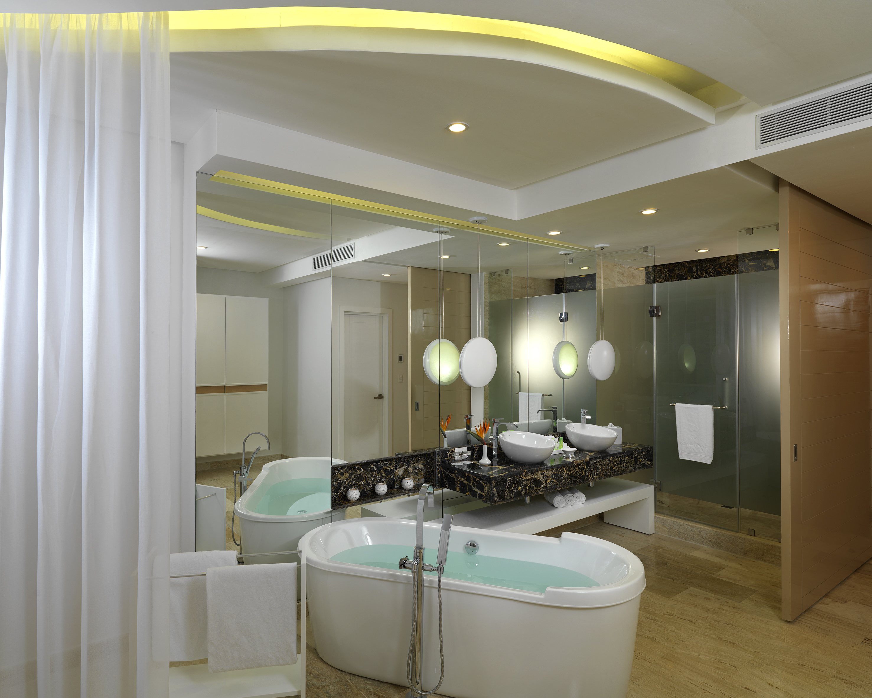 Modern luxury bathroom with freestanding tub, double vanity, and shower.