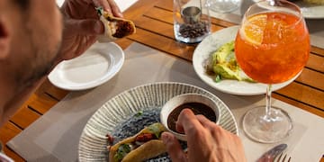 a man eating tacos at a table