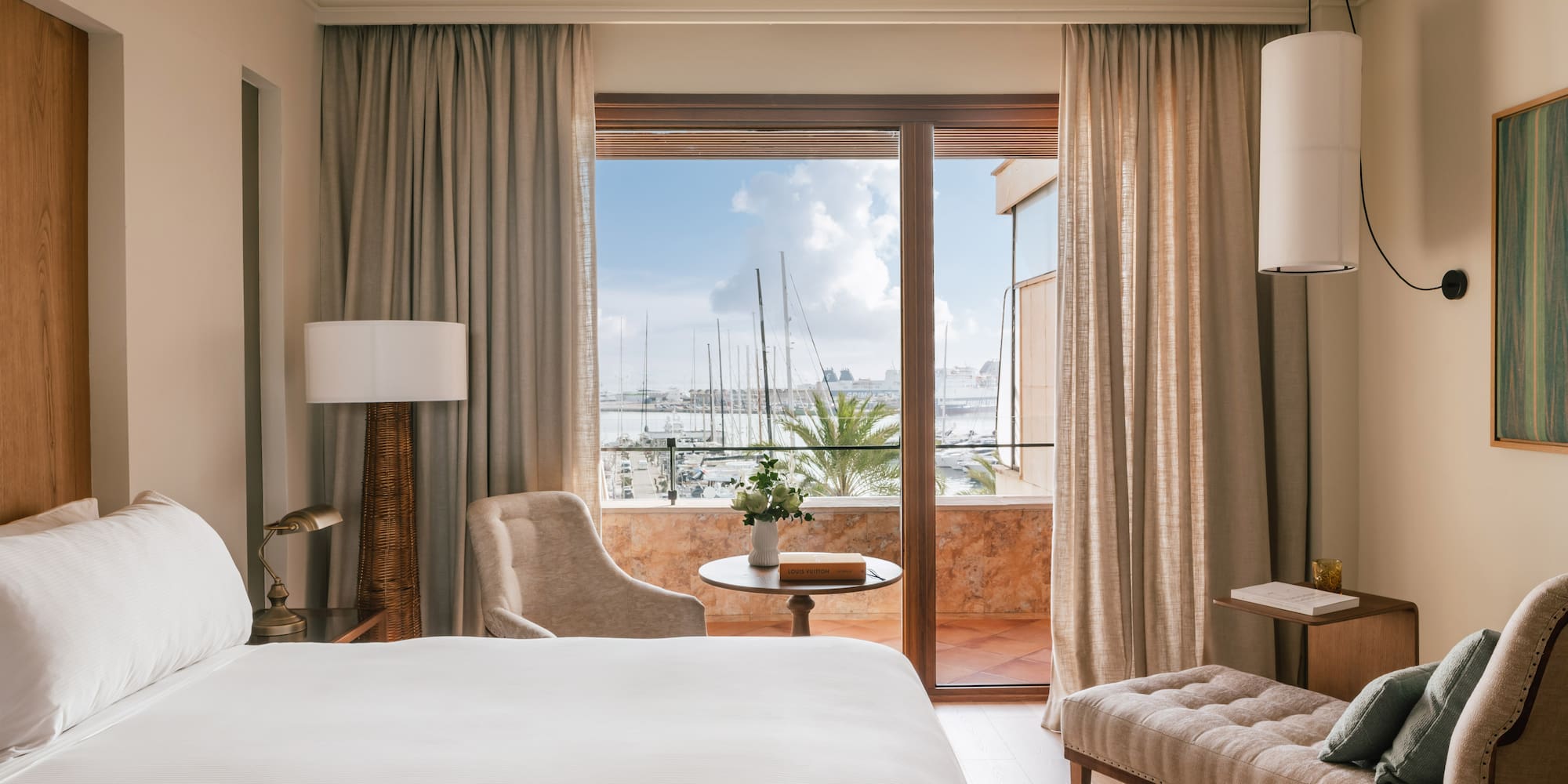 a room with a bed and a table and chairs