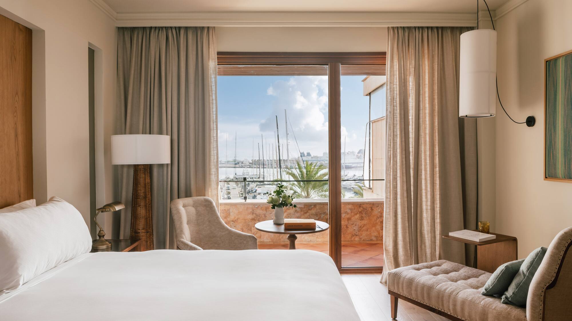 a room with a bed and a table and chairs