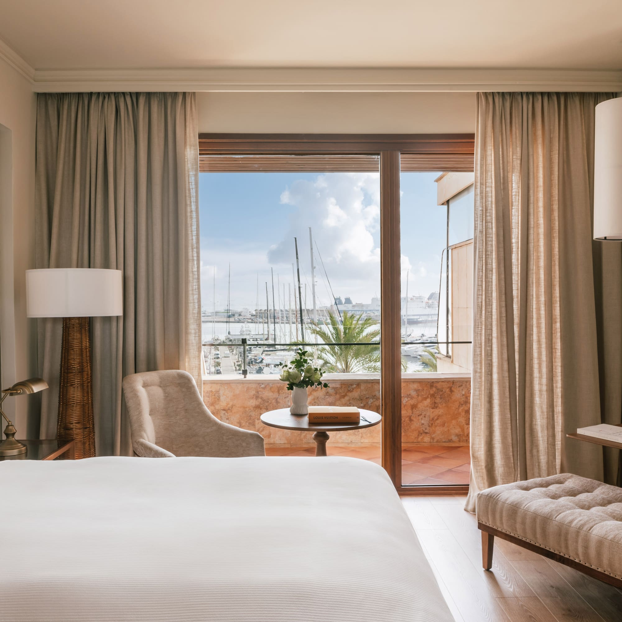 a room with a bed and a table and chairs