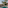 Tropical resort pool, palm trees, thatched gazebo, and distant ocean view.