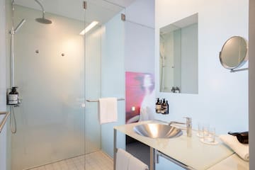 a bathroom with a glass shower and sink