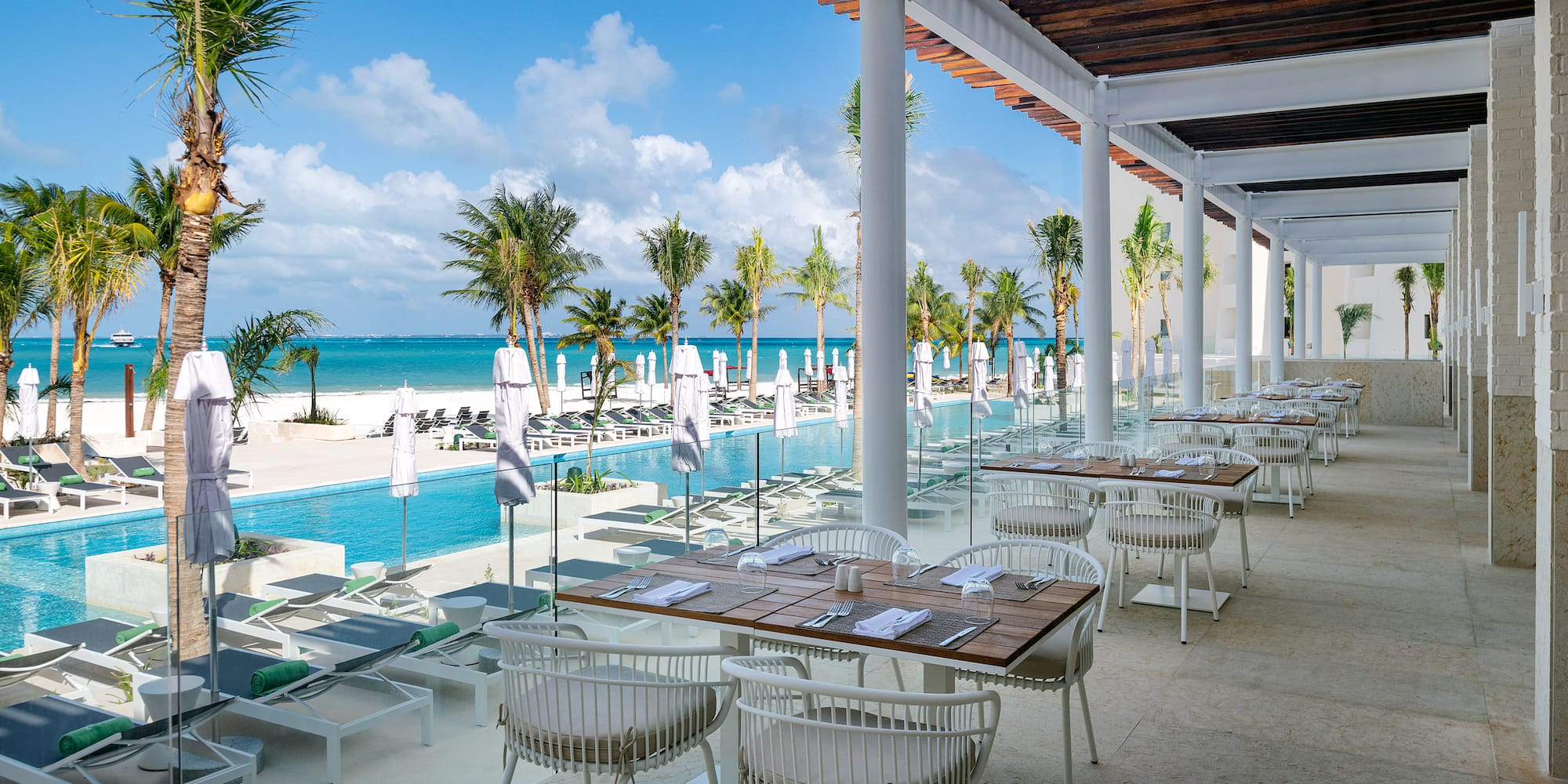 a restaurant with tables and chairs on a beach