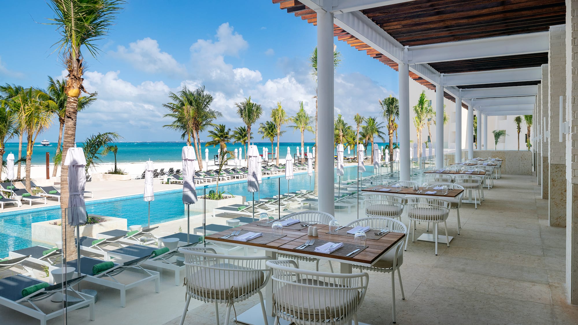 a restaurant with tables and chairs on a beach