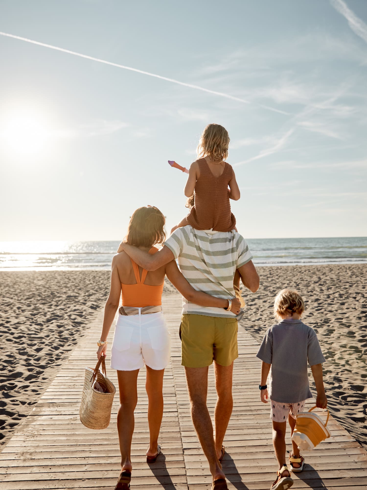 a group of people walking on a beach