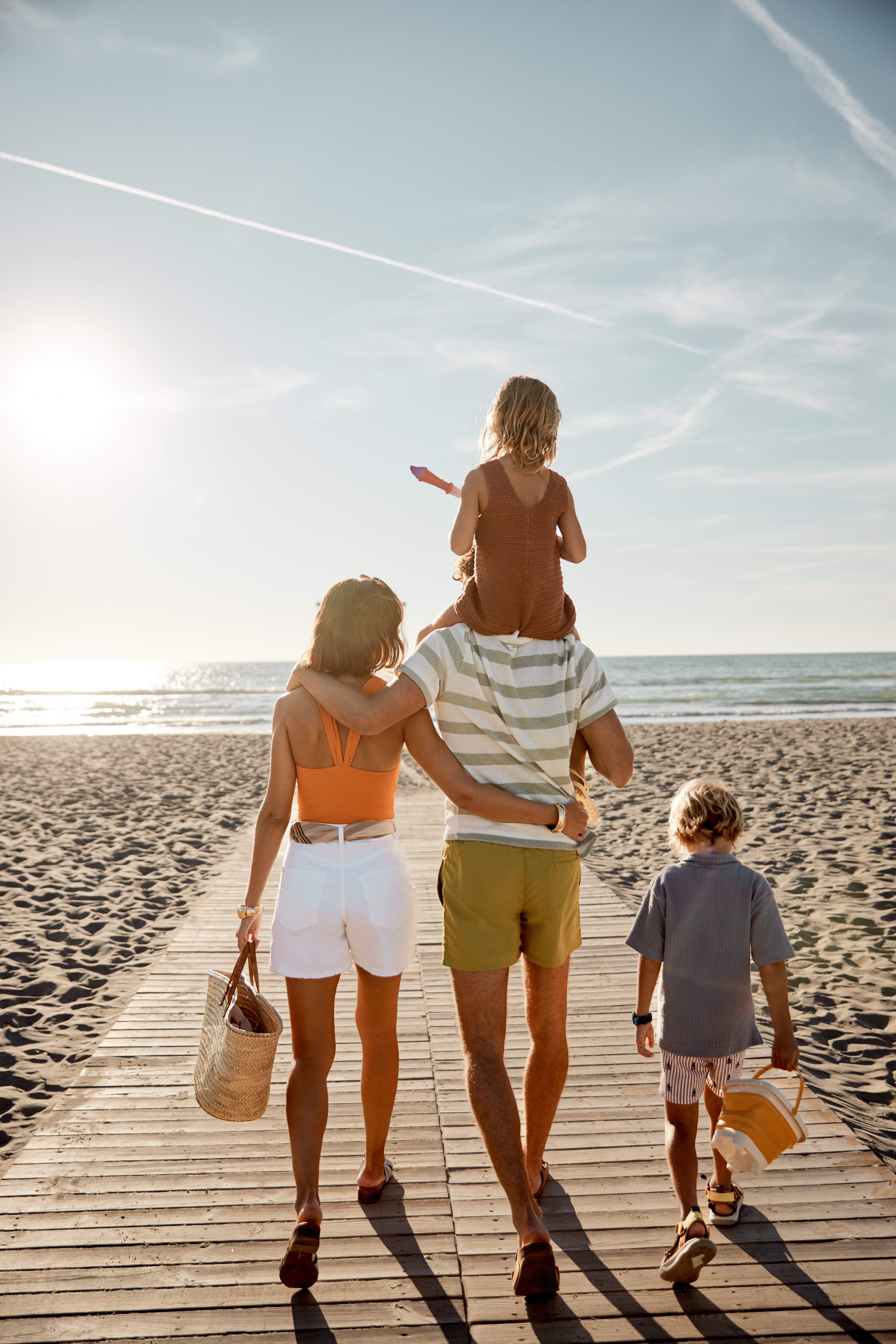 a group of people walking on a beach