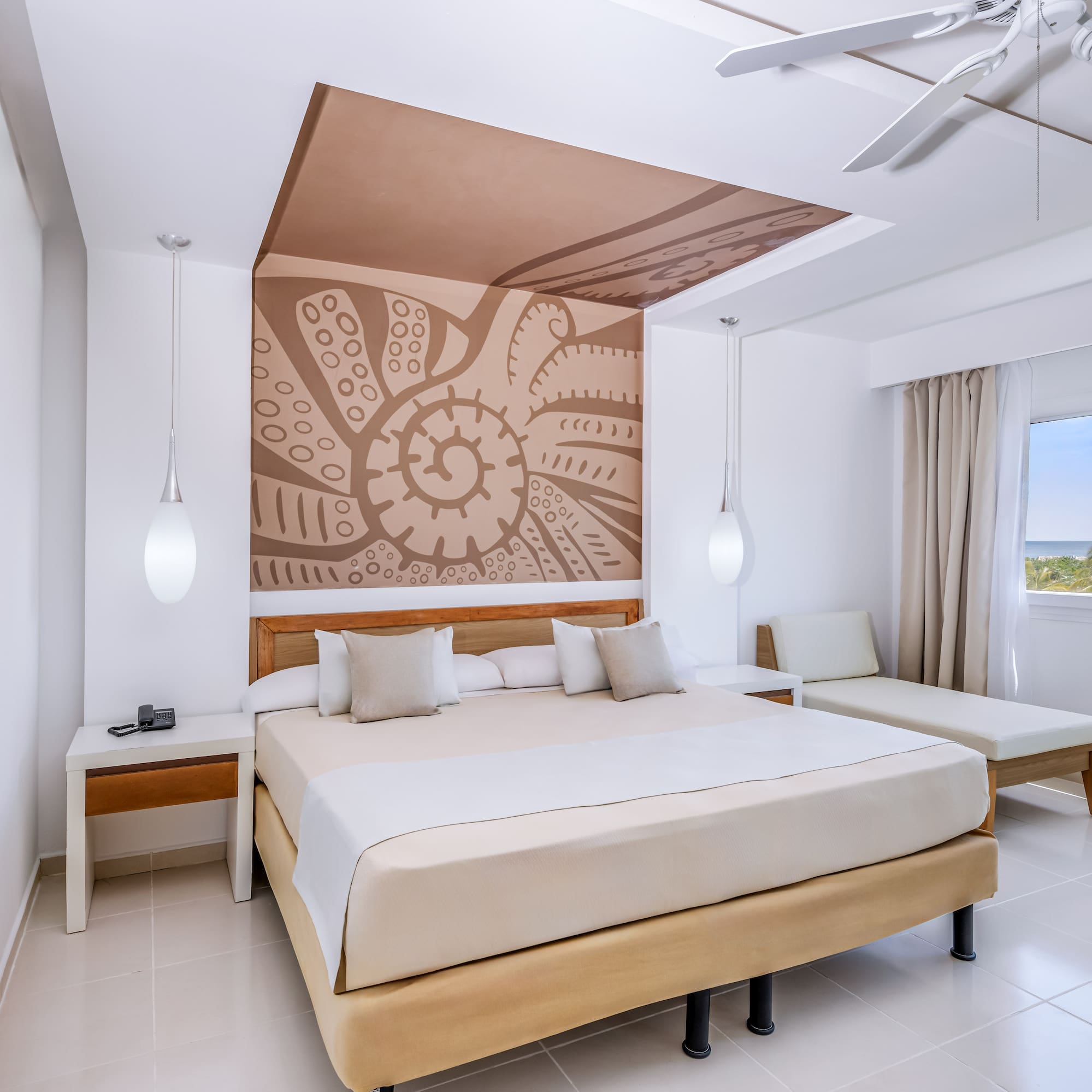 a room with a bed and a fan