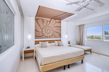 a room with a bed and a fan