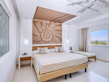 a room with a bed and a fan