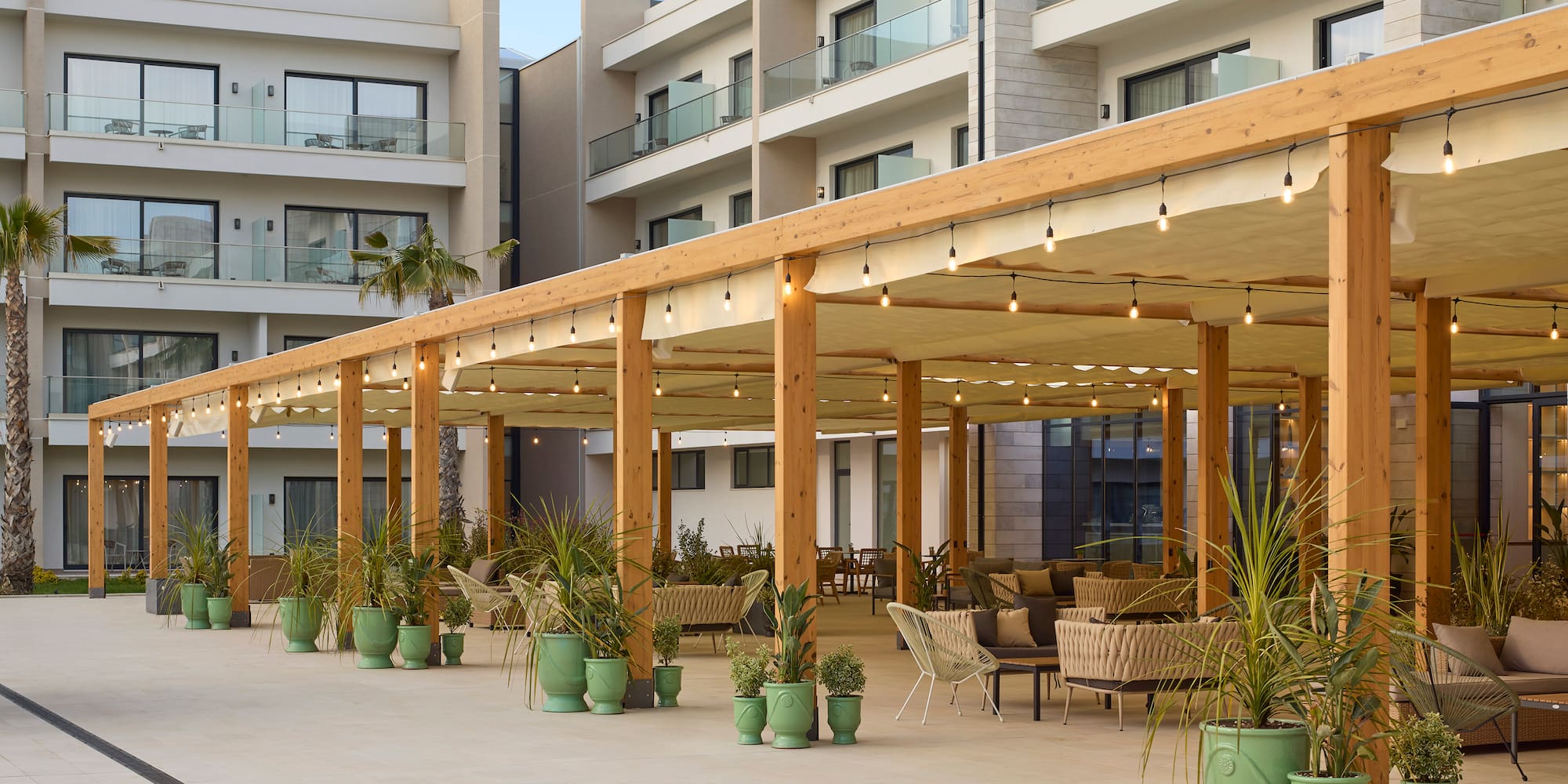 a patio with a covered area with chairs and a table and chairs