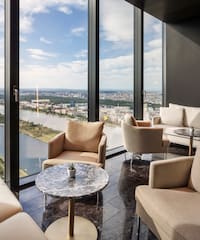 a room with a view of a city and a river