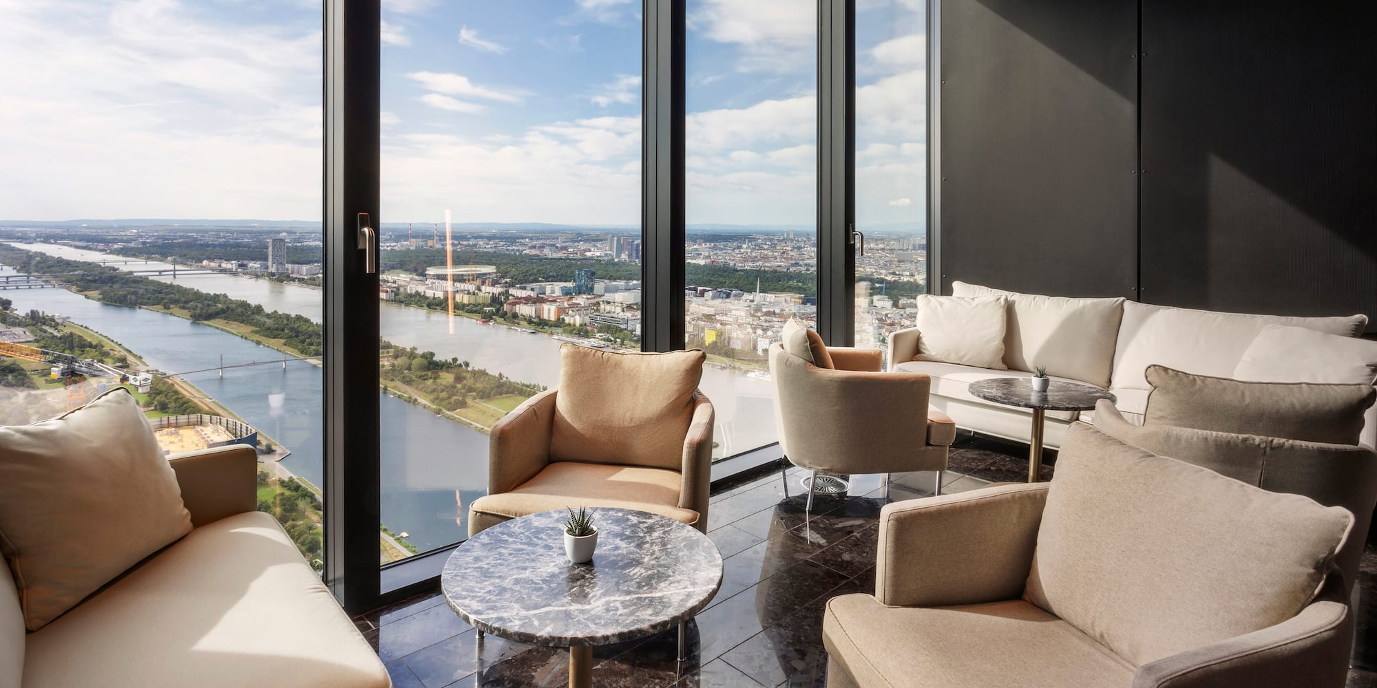 a room with a view of a city and a river