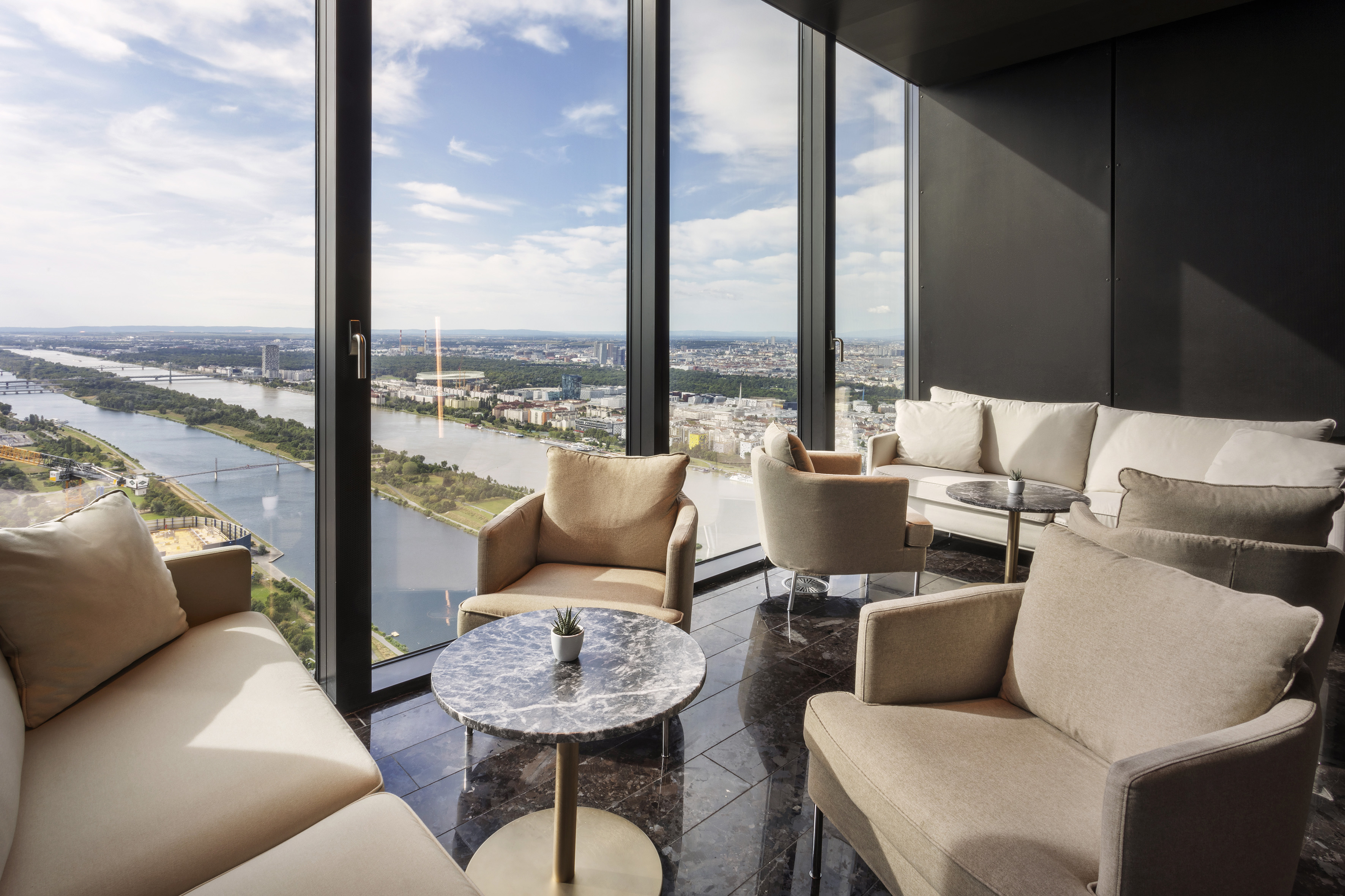 a room with a view of a city and a river