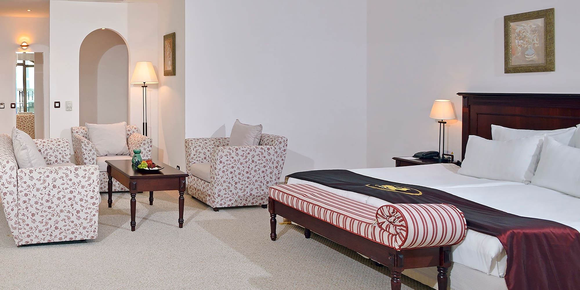 a bedroom with a bed and chairs