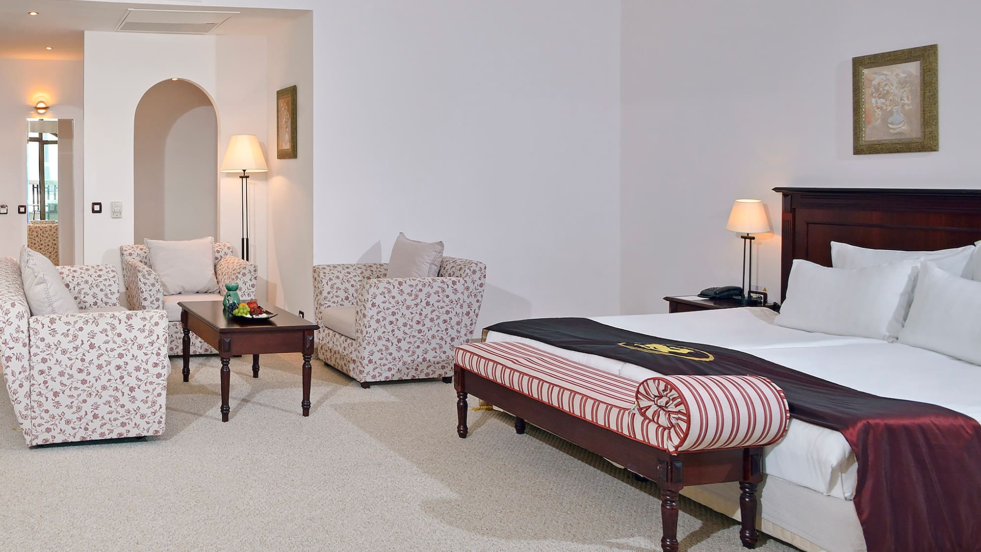 a bedroom with a bed and chairs