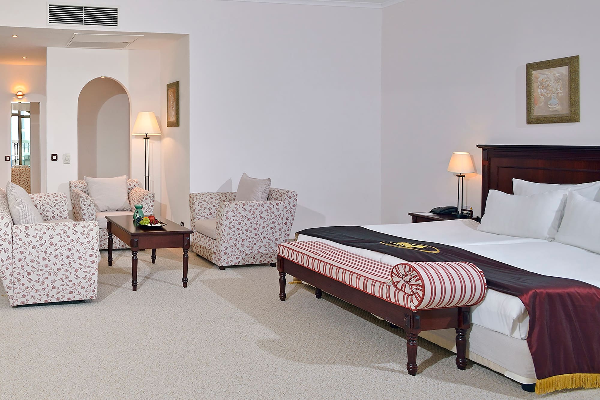 a bedroom with a bed and chairs