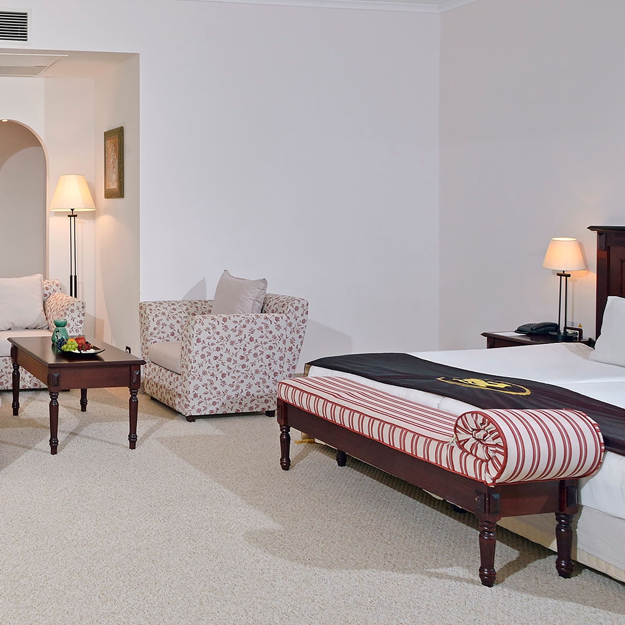 a bedroom with a bed and chairs