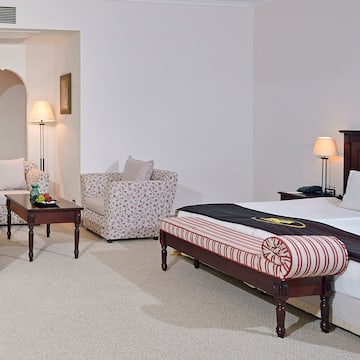 a bedroom with a bed and chairs