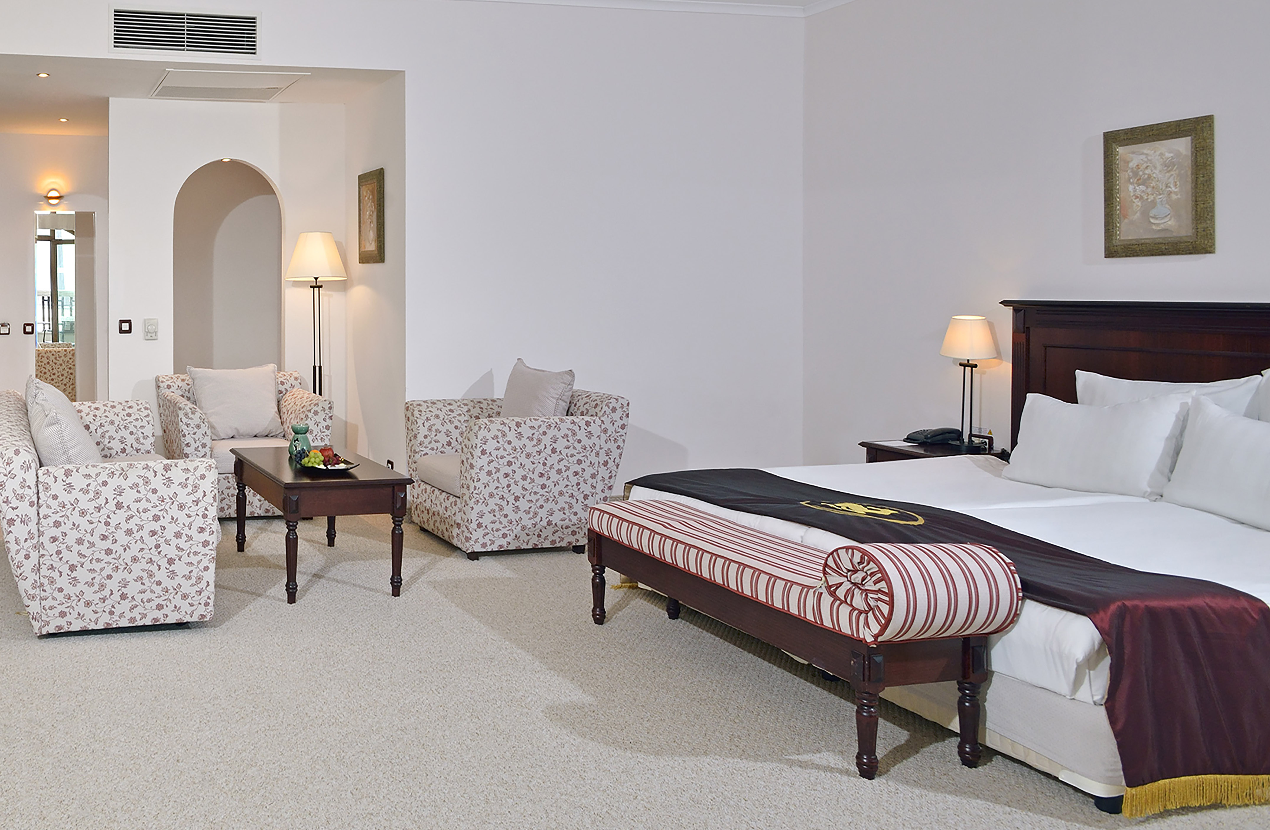 a bedroom with a bed and chairs