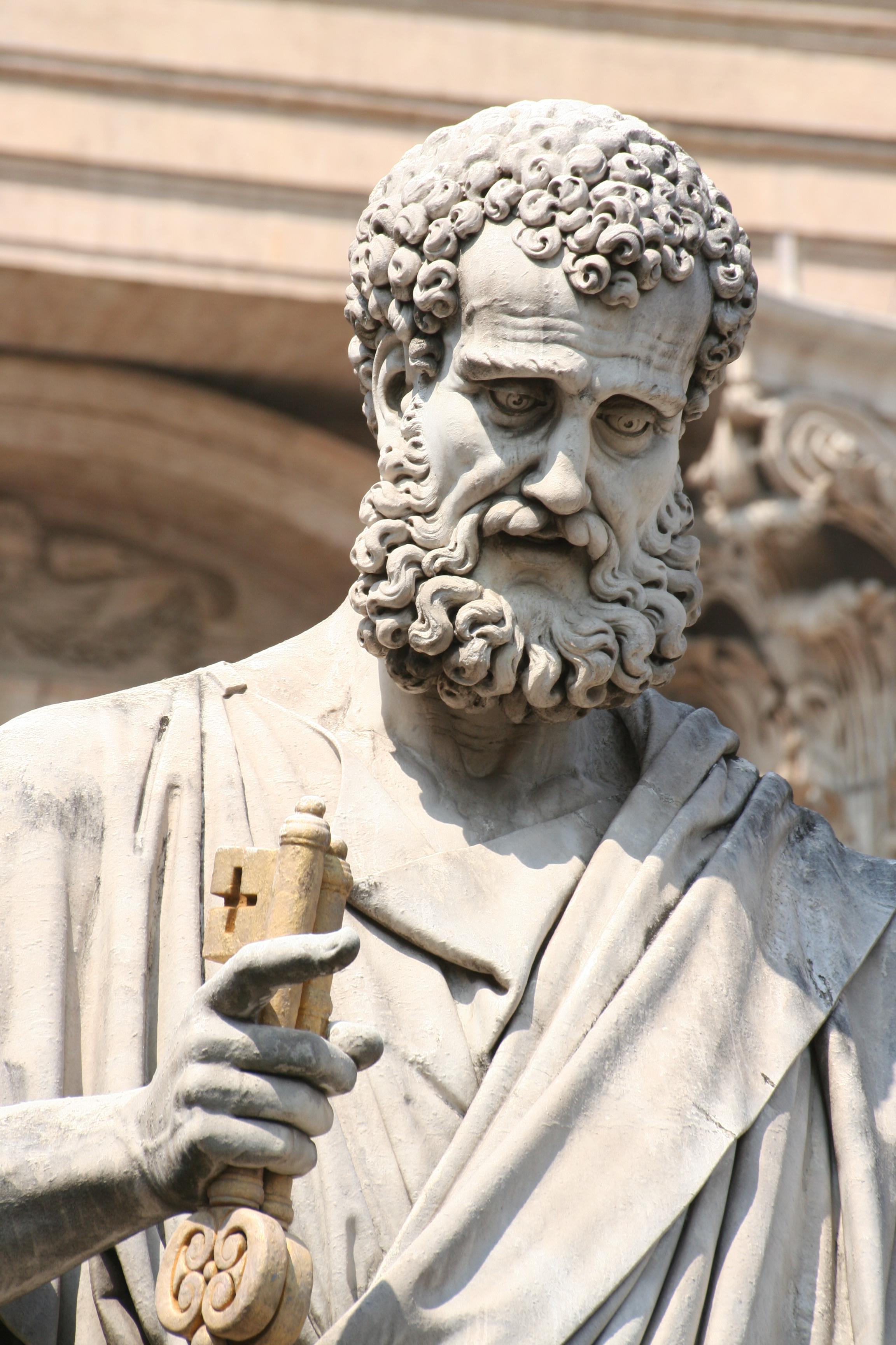 a statue of a man holding a book
