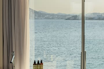 a bathtub with a view of the ocean