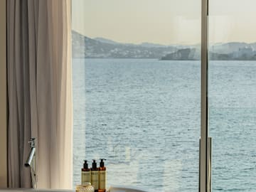 a bathtub with a view of the ocean