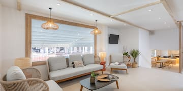 a room with a couch and chairs