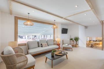 a room with a couch and chairs