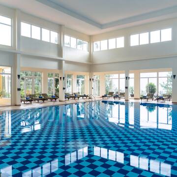 a large indoor pool with blue checkered flooring