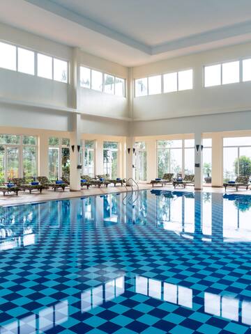 a large indoor pool with blue checkered flooring