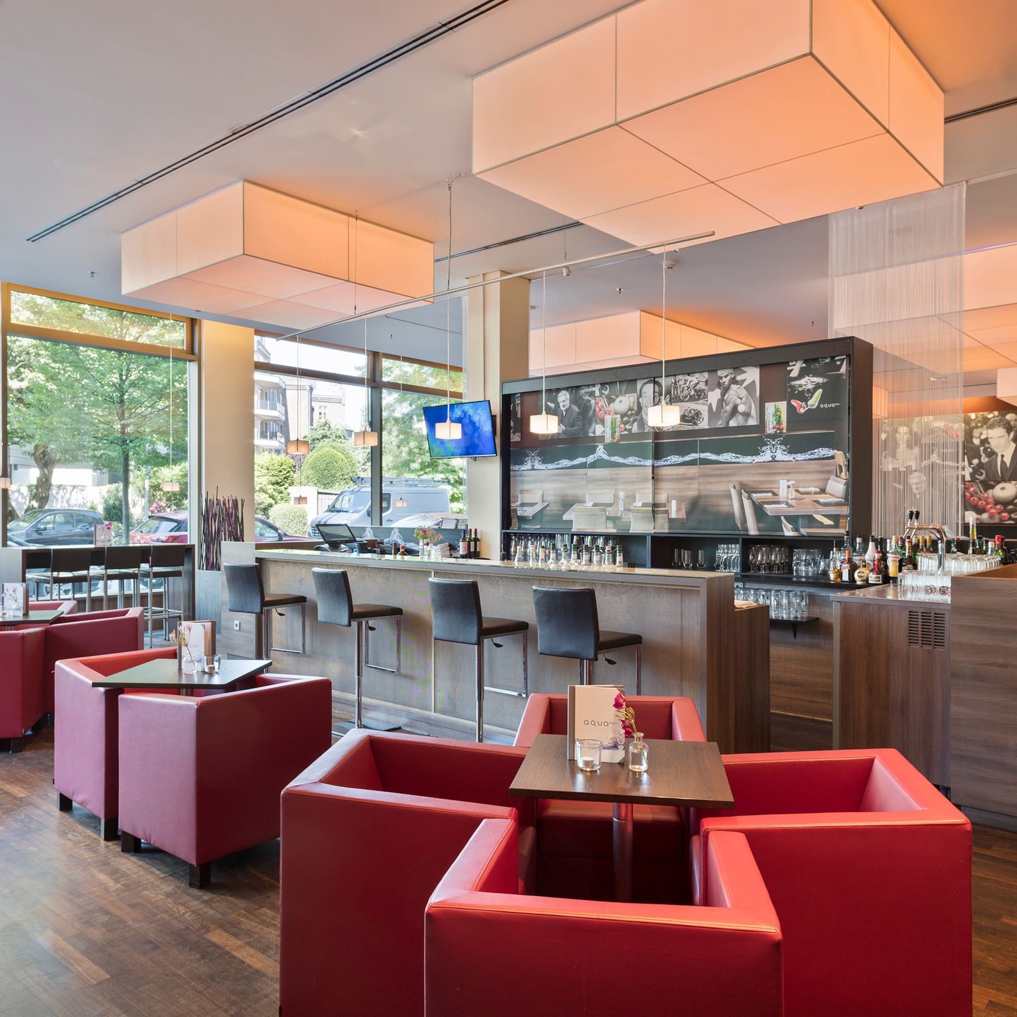 a room with large windows and a television