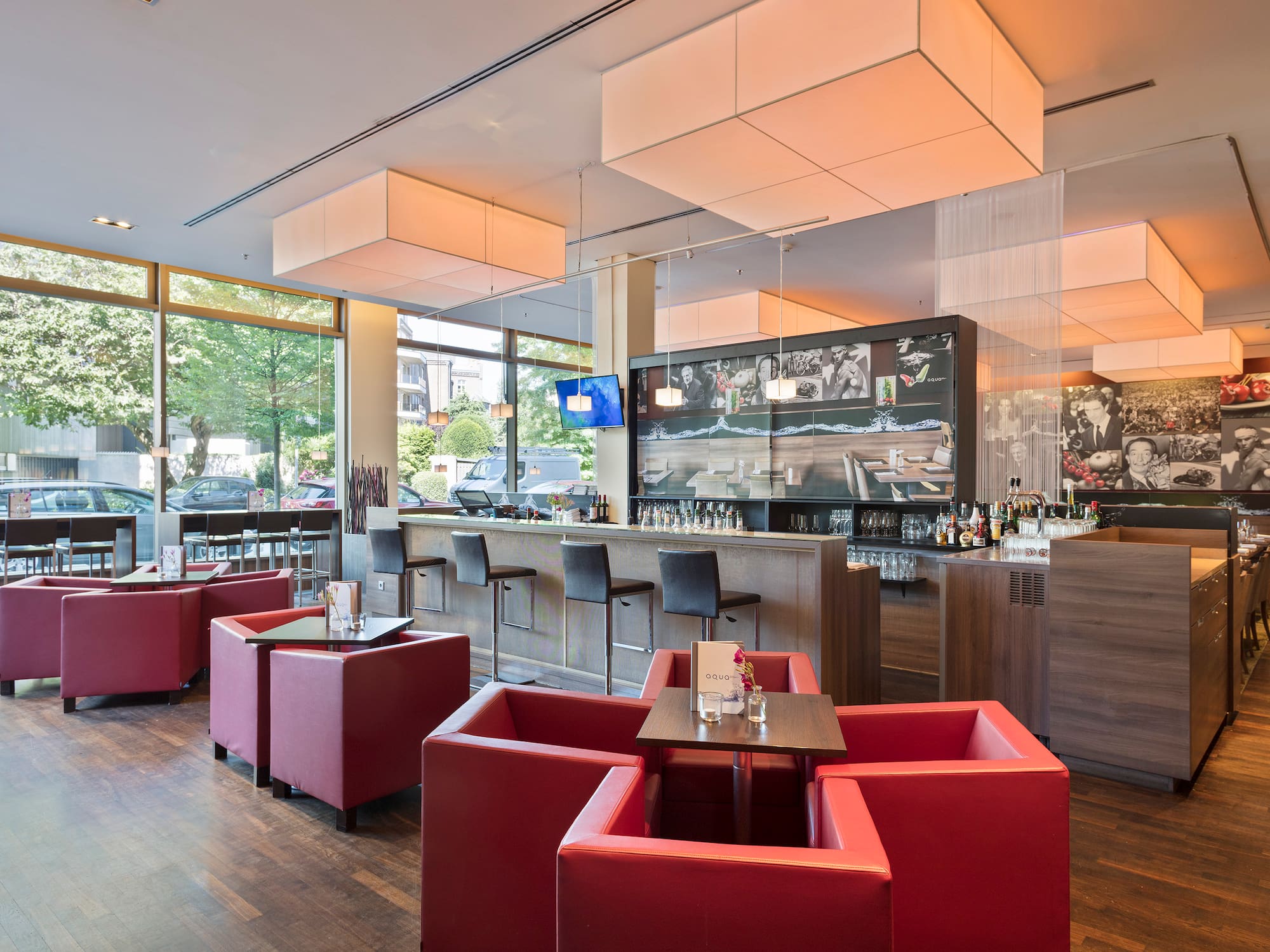 a room with large windows and a television