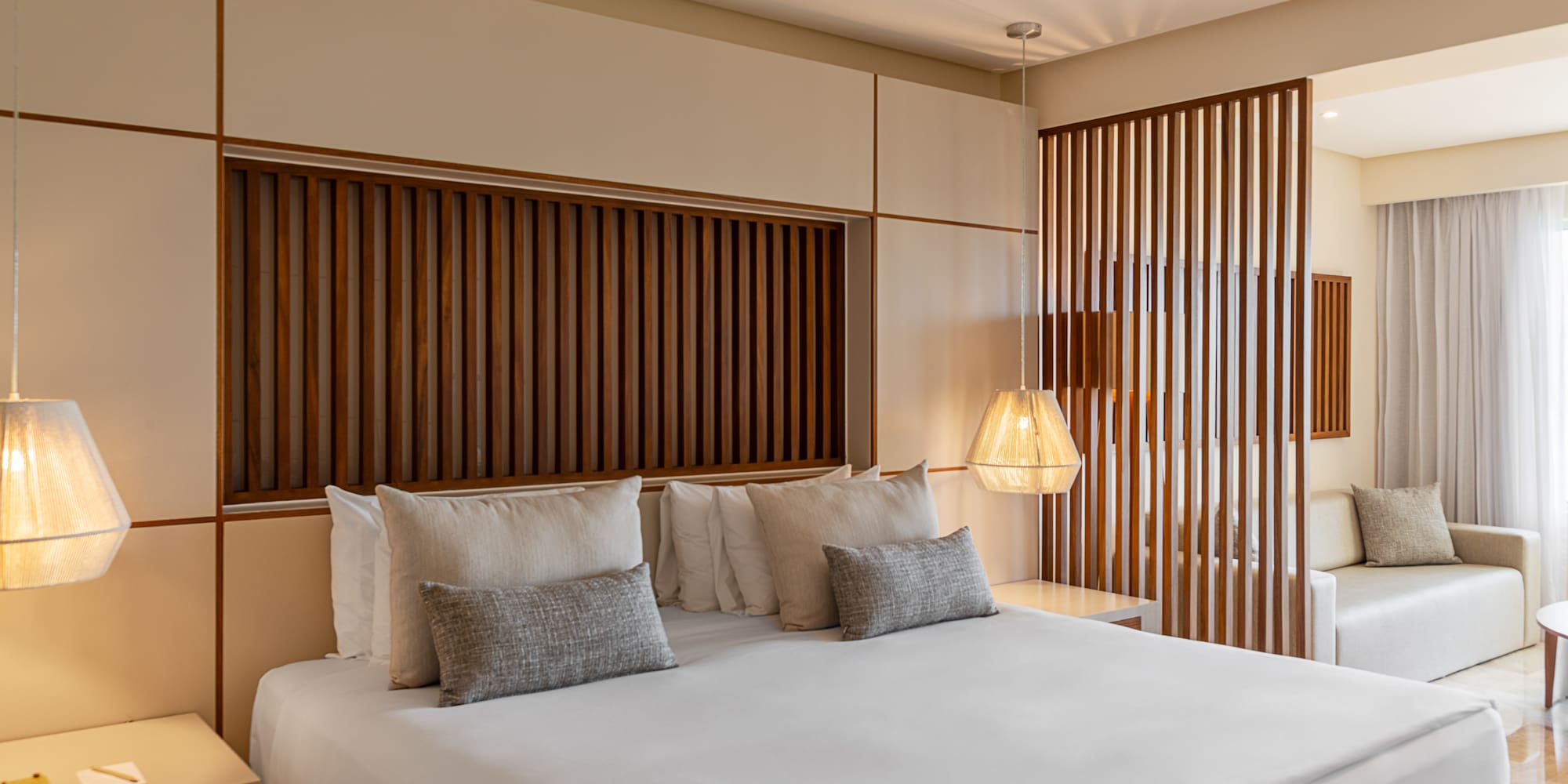 a bed with pillows and lamps in a room