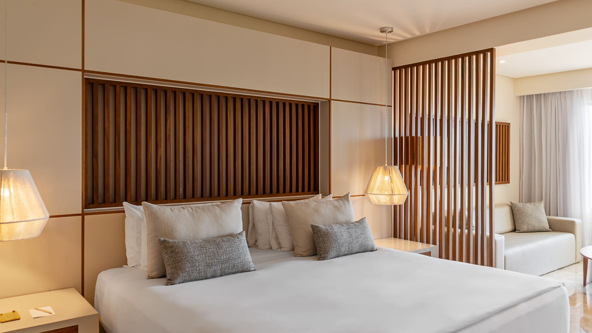 a bed with pillows and lamps in a room